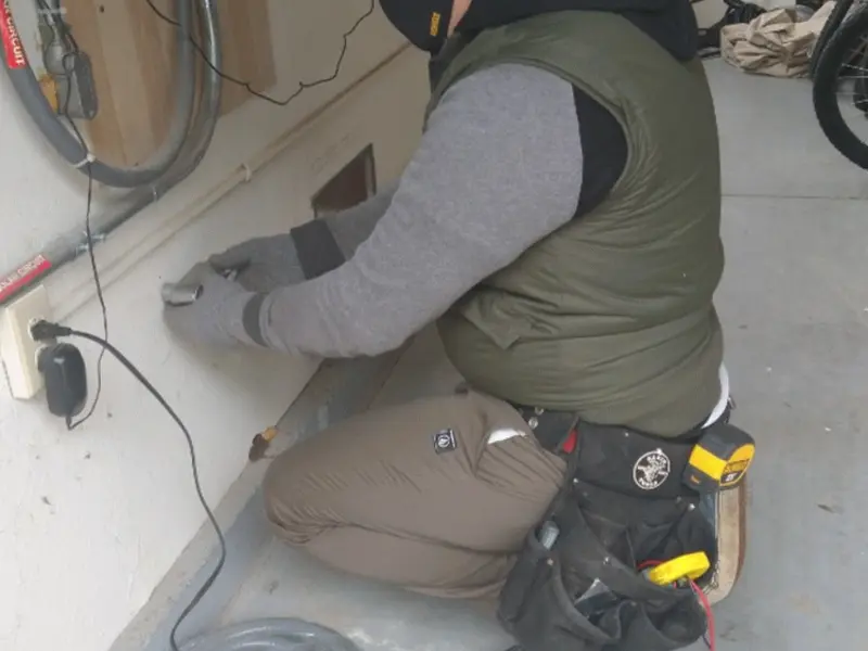 Electrician performing outlet wiring in a Shippensburg garage